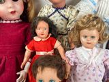 a lot of dolls that are sitting together on a table