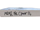the book is on a white surface with black writing on it