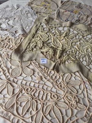 a lot of doily on a bed with a tag on it