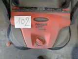 a red mower that has a price tag on it