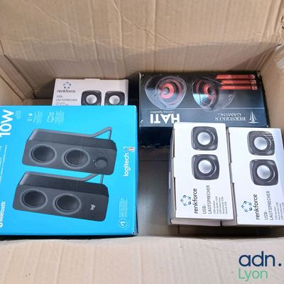 three speakers in a cardboard box on the floor