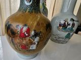 two vases sitting on a table with a curtain in the background