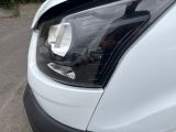a close up of a car ' s headlight on the street