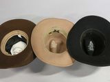 several hats are lined up on a white surface