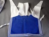 a blue and white apron on a table next to a pair of shoes
