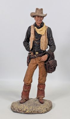 figurine représentant un homme en tenue de cow-boy, avec un chapeau et des bottes