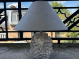 a lamp that is sitting on a table in front of a balcony
