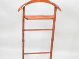 an image of a wooden clothes rack with a coat hanger