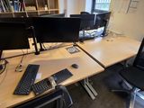 a desk with two computer monitors and a keyboard on it