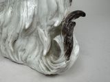 a figurine of a dog that is sitting on a table