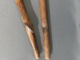 two wooden sticks that are sitting next to each other