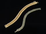 two gold bracelets on a black background