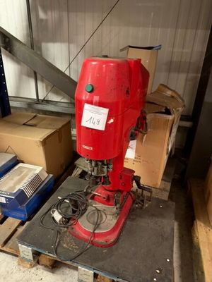 a red machine that is sitting on a pallet