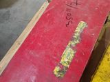 a red box sitting on top of a wooden table