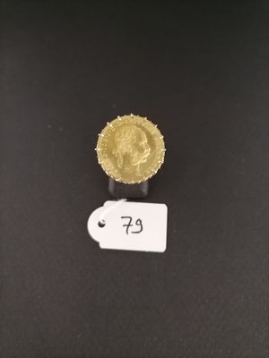 a close up of a gold coin on a black surface
