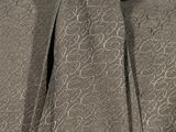 the woman is wearing a gray dress with a neck tie
