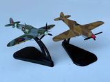 two model airplanes that are on display on a table