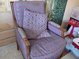 a chair that is sitting in front of a painting