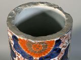 a vase with a flower design on it sitting on a table