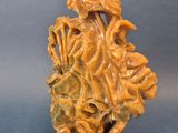an image of a carved figurine of a woman holding a flower
