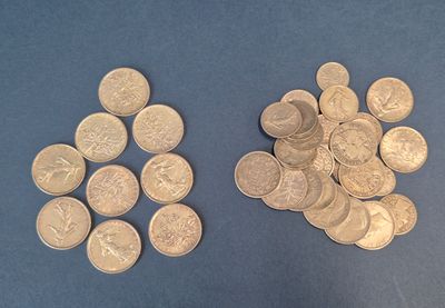 two piles of coins sitting on a blue surface
