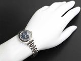 a woman ' s wrist with a watch on it