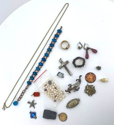 a white plate with a bunch of jewelry on it