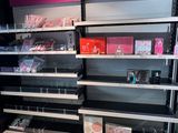 a lot of empty shelves in a store with perfumes