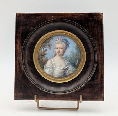 an old picture of a woman in a white dress in a wooden frame