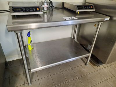 a stainless steel table with a bottle of water on it