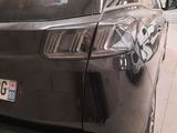 a car that is parked in a garage with its door open