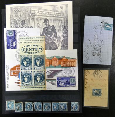 quelques vieux timbres et cartes postales sont posés sur une table noire