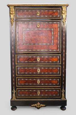 an antique chest of drawers with a wooden top and gold trimmings