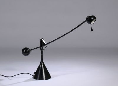 a close up of a black lamp on a white surface