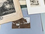 a pile of books with pictures on them on a table