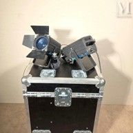 two lights that are sitting on top of a case