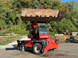 a red truck with a large bucket on it ' s back