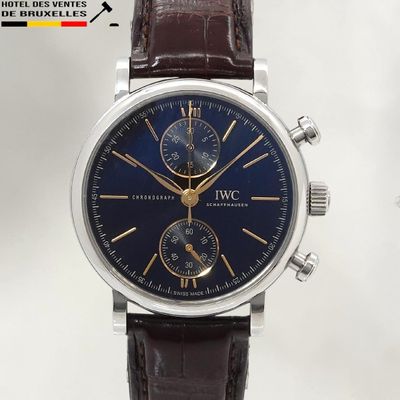 a close up of a wrist watch with a blue dial