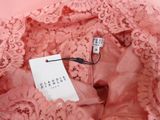 a close up of a pink dress with a tag on it