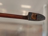 a wooden stick with a handle that has a piece of wood sticking out of it