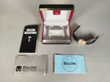 a box with a watch and other items on a table