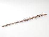 an old silver flute with a wooden handle on a white surface