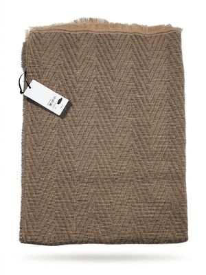 a brown blanket with a tag on top of it