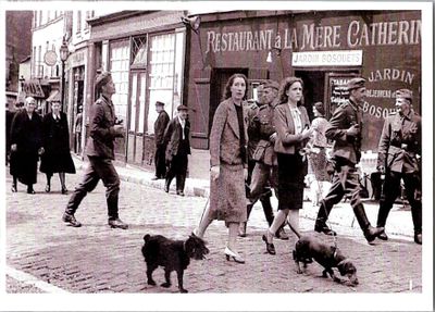 a black and white photo of people walking down the street with a dog