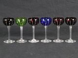 six wine glasses are lined up in a row on a black background