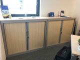 a room with a desk and a cabinet in it