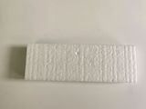 a close up of a piece of paper on a white surface