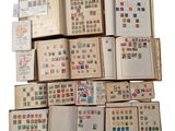 several open books are stacked on top of each other with stamps on them