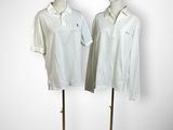 pair of mannequins wearing white shirts and a red hat