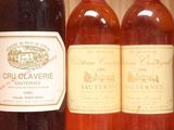 several bottles of wine are lined up on a shelf